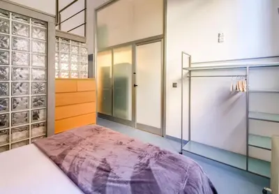 a large room with a closet with a large purple rug at Camp Nou Apartment in Hospitalet de Llobregat