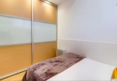 a bedroom with a bed and a window at Camp Nou Apartment in Hospitalet de Llobregat