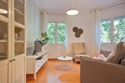a living room with a couch and a table at Alcam Paseo San Juan in Barcelona
