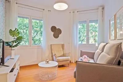 a living room with a couch and a table at Alcam Paseo San Juan in Barcelona