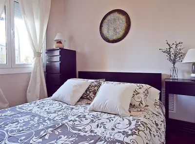 a bedroom with a bed with pillows and a window at Ciutadella Park Born in Barcelona