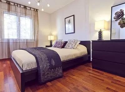 a bedroom with a bed and a dresser and a window at Ciutadella Park Born in Barcelona