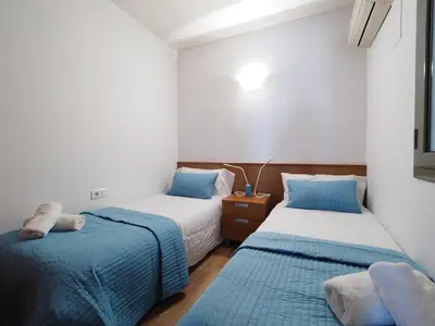 two beds in a room with blue and white at Paseo de Gracia Design in Barcelona