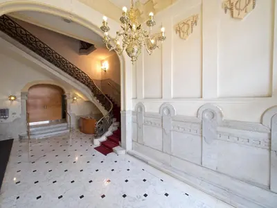 a hallway with a chandelier and stairs in a building at Paseo de Gracia Design in Barcelona