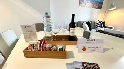 a bottle of wine and two glasses on a table at Paseo de Gracia Design in Barcelona