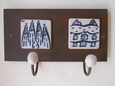 a wooden switch with two stickers on the wall at Pension Alamar in Barcelona