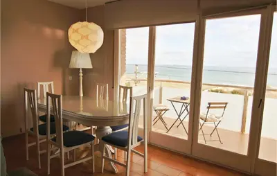 a dining room with a table and a view of the ocean at Gorgeous Apartment In Pineda De Mar in Pineda de Mar