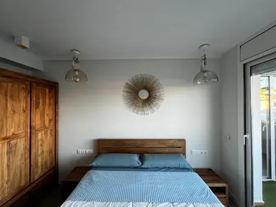 a bedroom with a bed and a mirror on the wall at La Marina de Aiguadolç in Sitges