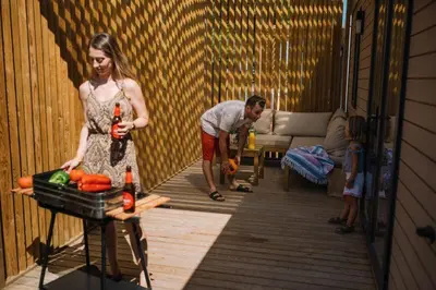 a man and a woman standing in a living room at Camping Sènia Caballo de Mar in Pineda de Mar