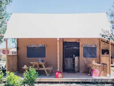 a small house with a table and a table at Camping Sènia Caballo de Mar in Pineda de Mar