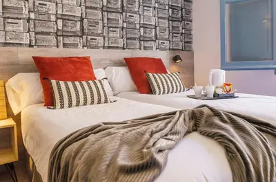 two beds with pillows and a blanket on them at BYPILLOW Wander in Barcelona