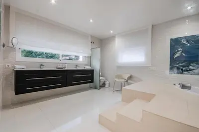a white bathroom with a sink and a tub at Luxurious Villa Marly I to two minutes the beach in Castelldefels