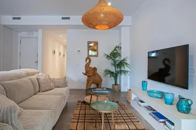 a living room with a couch and a tv at Destino Sitges in Sitges