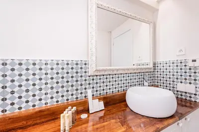 a bathroom with a large white sink and a mirror at Sweett - Atic Eloi in Barcelona