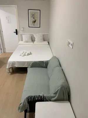 two beds sitting next to each other in a room at Plaza de España independent house in Barcelona