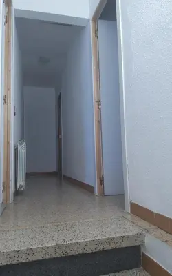 an empty room with a hallway with two doors at Holidays Domus Iano in Esparreguera
