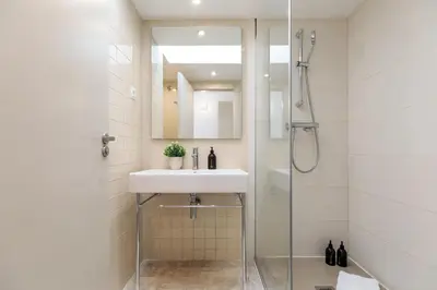 a bathroom with a sink and a shower at Ola Living Merce in Barcelona