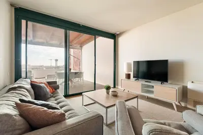 a living room with a couch and a flat screen tv at Ola Living Merce in Barcelona