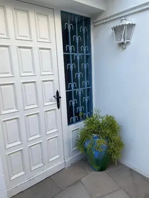 a white door with a plant in front of it at Studio Relax by Hello Homes Sitges in Sitges