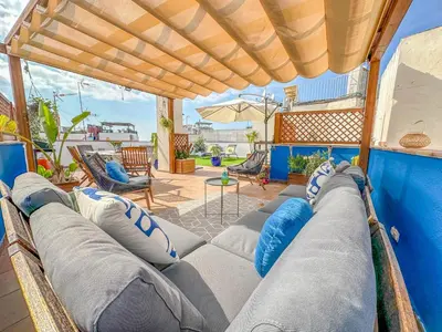 a living room with a bunch of pillows at Sanctuary Penthouse by Hello Homes Sitges in Sitges