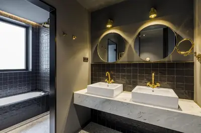 a bathroom with two sinks and a mirror at Room Mate Collection Gerard, Barcelona in Barcelona