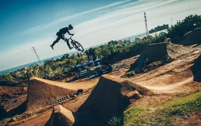a man doing a trick on a dirt bike in the air at Next to the sea 20' from Barcelona in Premiá de Mar