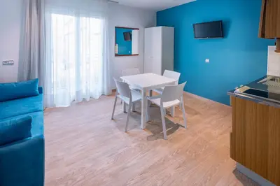 a dining room with a white table and chairs at GHT Balmes, Hotel-Aparthotel&SPLASH in Calella