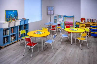 a classroom with tables and chairs in a classroom at GHT Balmes, Hotel-Aparthotel&SPLASH in Calella