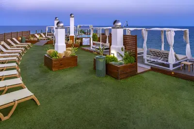 a deck of a cruise ship with chairs and the ocean at GHT Maritim in Calella