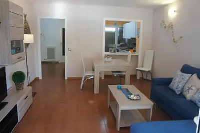 a living room with a blue couch and a table at Musclera in Arenys de Mar