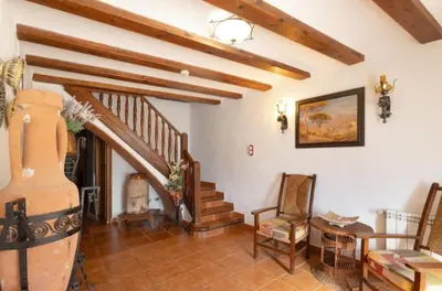 a bedroom with a green bed and a fireplace at Cal Vidal in Mura