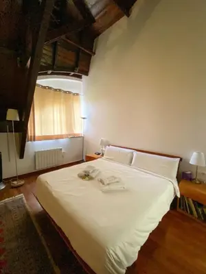 a bedroom with a large white bed with white sheets at Passeig de Gracia Studio Loft in Barcelona