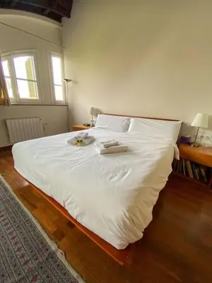 a white bed with two towels on it in a bedroom at Passeig de Gracia Studio Loft in Barcelona