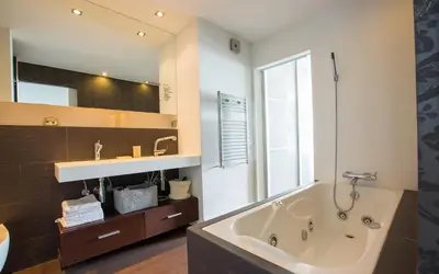 a bathroom with a large tub and a sink at Gava Beach 1st Line in Gavà