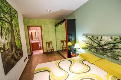 a bedroom with a tree mural on the wall at Catalunya Casas Modern and spacious with private pool close to BCN in Senmanat