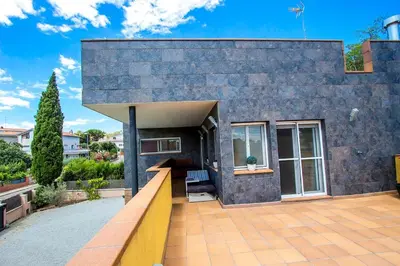 a house with a stone wall and a patio at Catalunya Casas Modern and spacious with private pool close to BCN in Senmanat