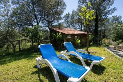 three blue and white chairs sitting in the grass at Catalunya Casas Peaceful Perfection , only 30km from Barcelona! in Vacarisas