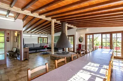a living room with a large wooden table and chairs at Catalunya Casas Nature and Tranquility for 24 pax - 30km to beach in Sant Pere de Vilamajor