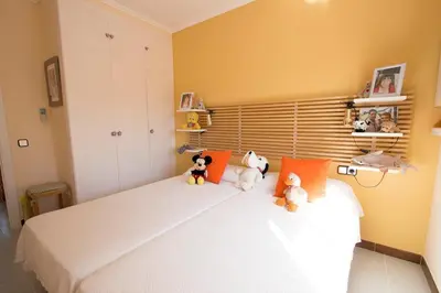 three stuffed animals sitting on a bed in a bedroom at Catalunya Casas Mountain escape with amazing views just 25km to BCN! in Torrelles de Llobregat