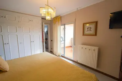 a bedroom with a bed and a sliding glass door at Catalunya Casas Mountain escape with amazing views just 25km to BCN! in Torrelles de Llobregat