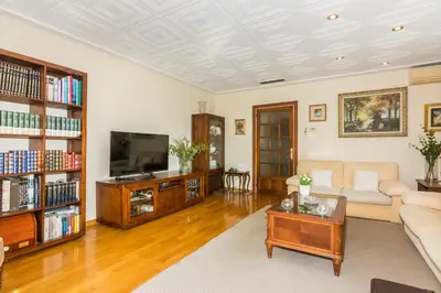a living room with a couch and a tv at HomeHolidaysRentals Amaral in Pineda de Mar