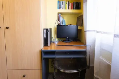 a desk with a computer and a monitor on it at David's House in Barcelona