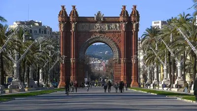 an archway in a city with people walking through it at David's House in Barcelona