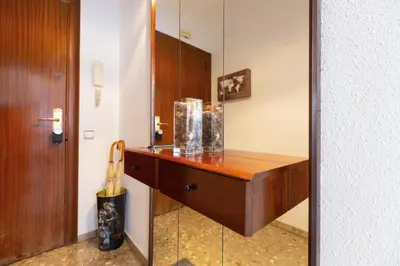 a bathroom with a wooden vanity with a mirror at David's House in Barcelona