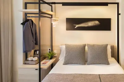 a bedroom with a bed with a fish on the wall at Hotel Denit Barcelona in Barcelona