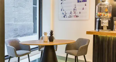 a table and two chairs in a room at Hotel Denit Barcelona in Barcelona