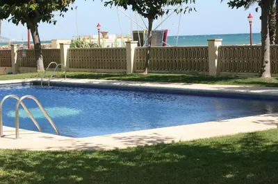 a swimming pool in a yard next to a fence at Apartment Foix in Cubelles