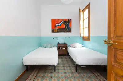 three beds in a room with blue walls at Casa Cosi Mallorca I in Barcelona