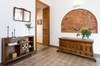 a living room with a mirror and a brick wall at Casa Cosi Mallorca I in Barcelona