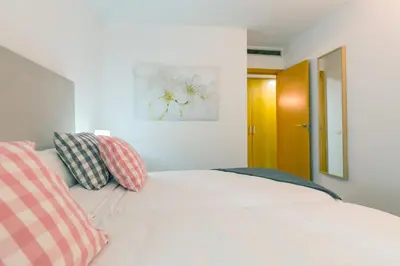 a bedroom with a bed with two pillows on it at Apartamentos Cornellalux 2 in Cornellà de Llobregat